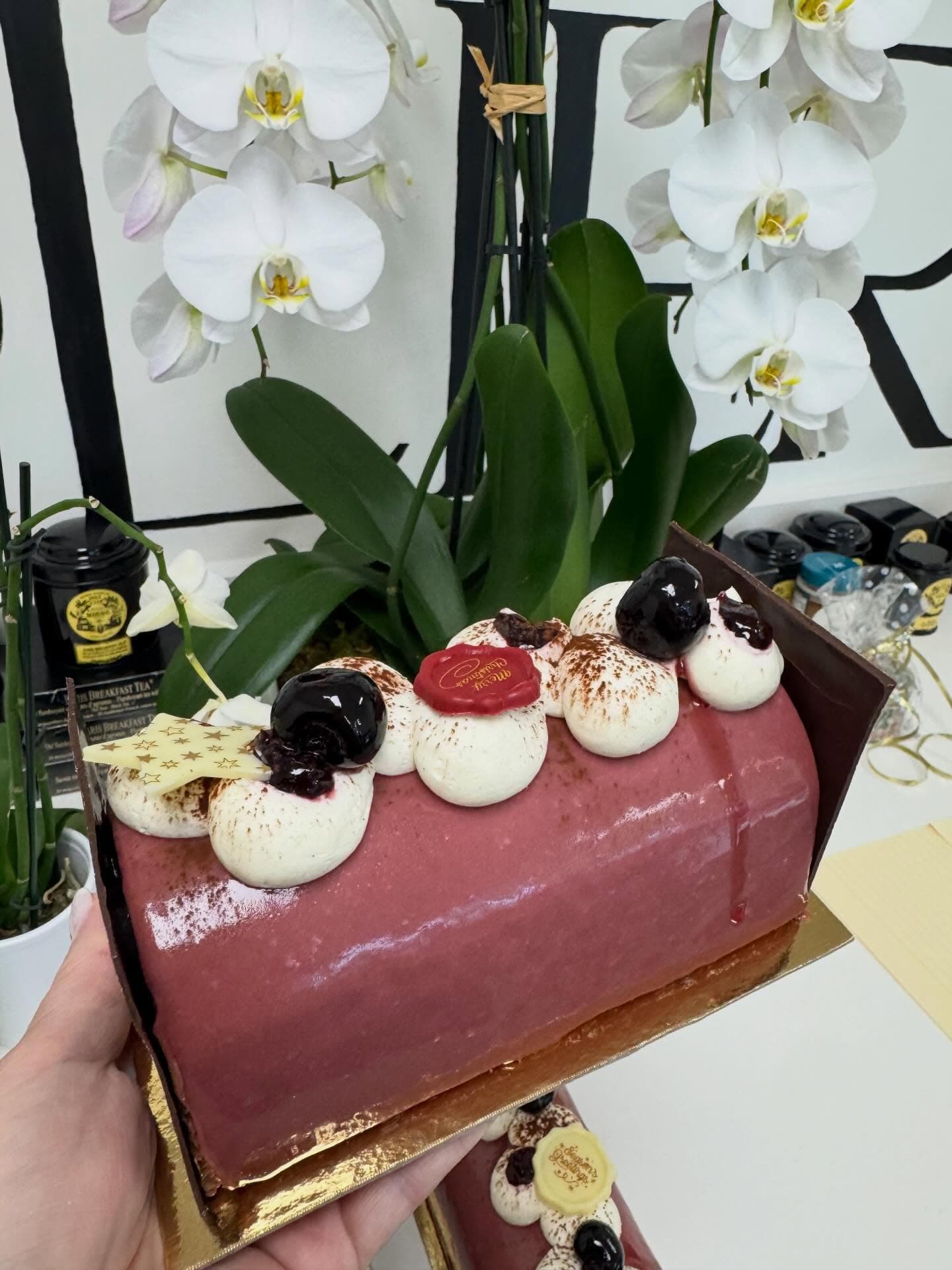 A glazed chocolate and berry holiday log cake
