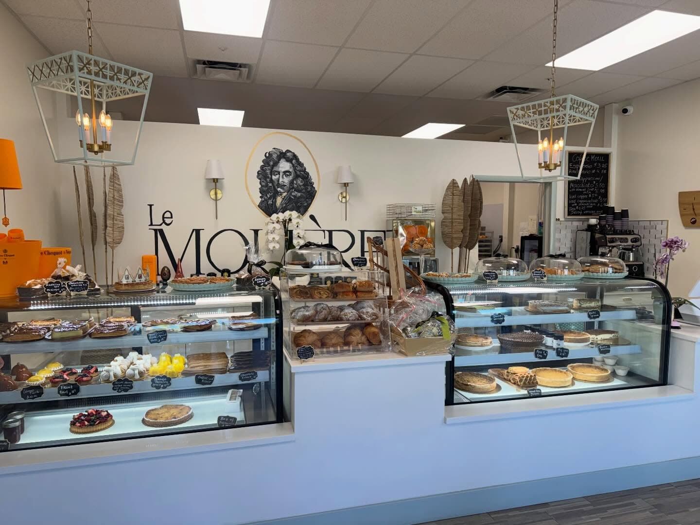 The Le Molière pastry counter with display cases and hanging lantern lights