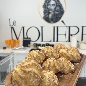Tray of golden coconut-crusted choux pastries
