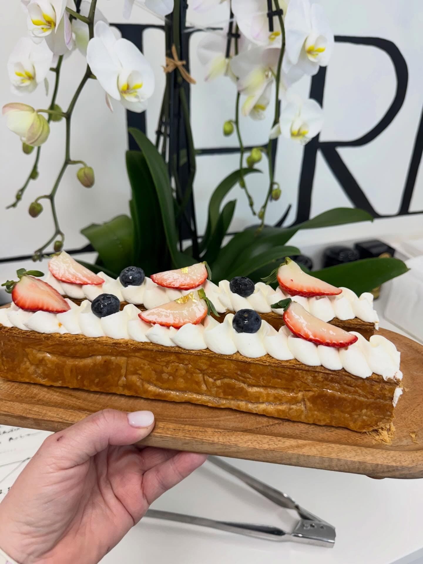 Mille-feuille pastry topped with strawberries and blueberries