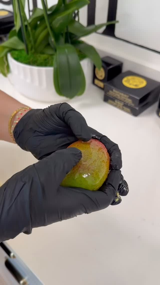 A pastry chef shaping a mango trompe-l'œil creation